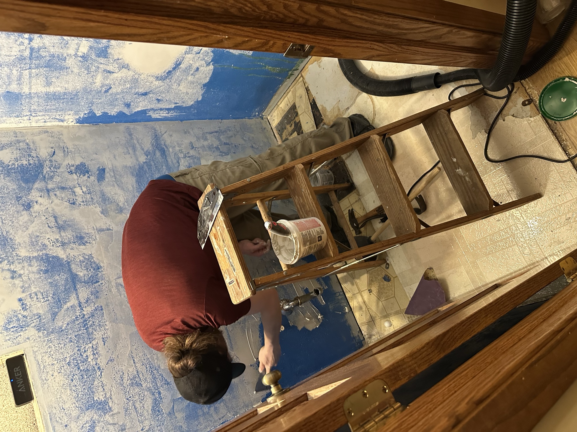 Joe on ladder painting bathroom